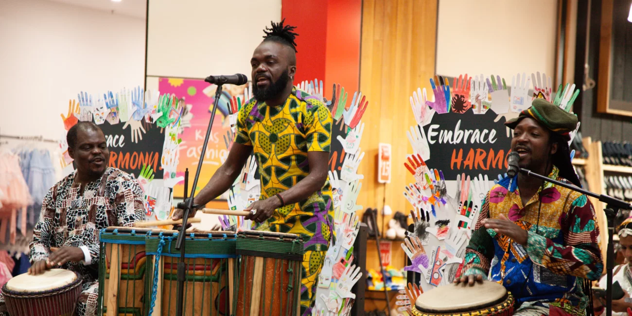 Harmony Week Activities to Celebrate Diversity in the Classroom - this photo features 3 West African performers, drumming at a Harmony Week Event.